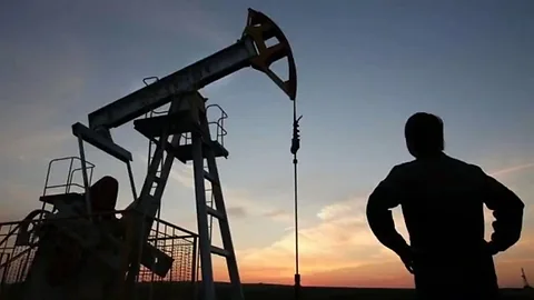 Oil industry pumpjack at dusk